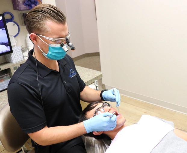 Dental professional performing an oral examination on a patient