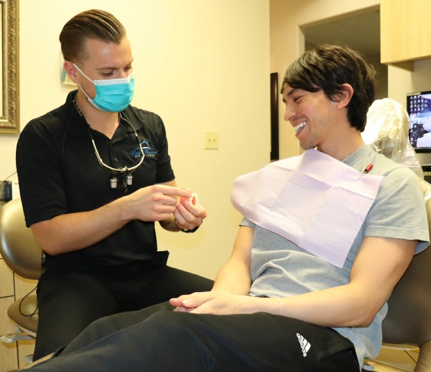 Dental professional discussing implant treatment with a patient