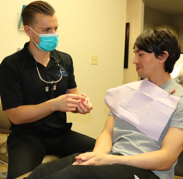 Dental professional discussing dentures with a patient