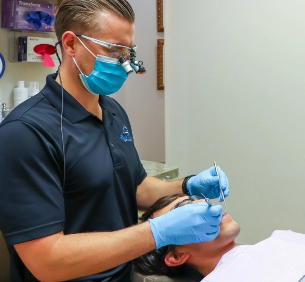 Dentist treating a patient during an emergency dental visit