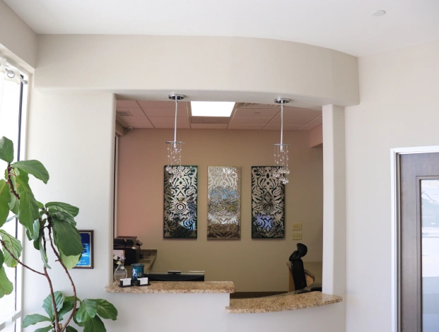 Welcoming dental practice reception area with seating and indoor plants