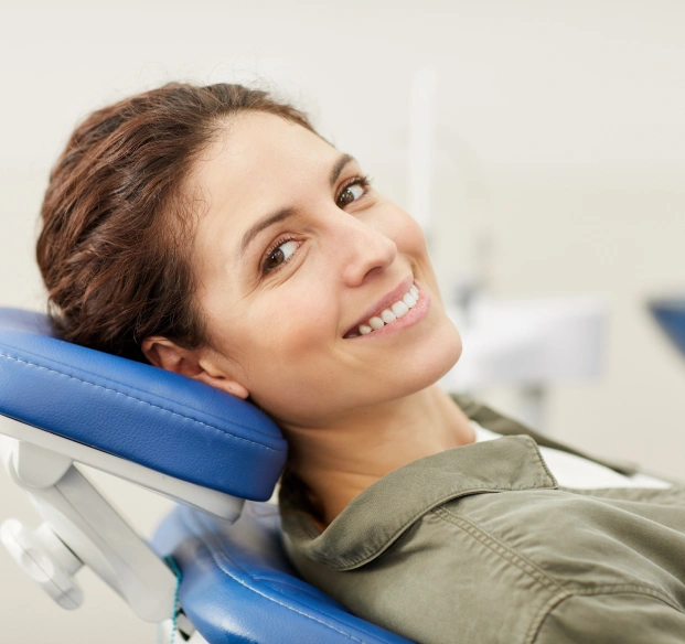 Smiling dental patient seated in a dental chair