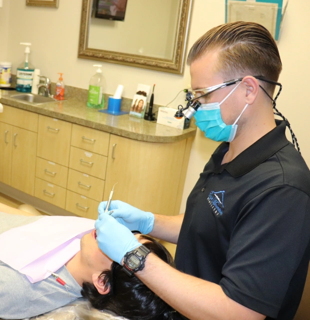 Dentist providing periodontal treatment to a patient