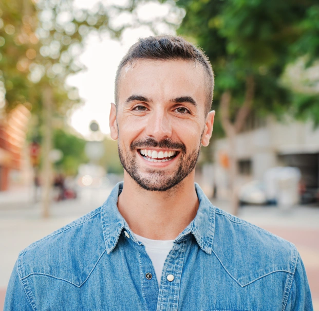 Smiling man representing professional teeth whitening treatment